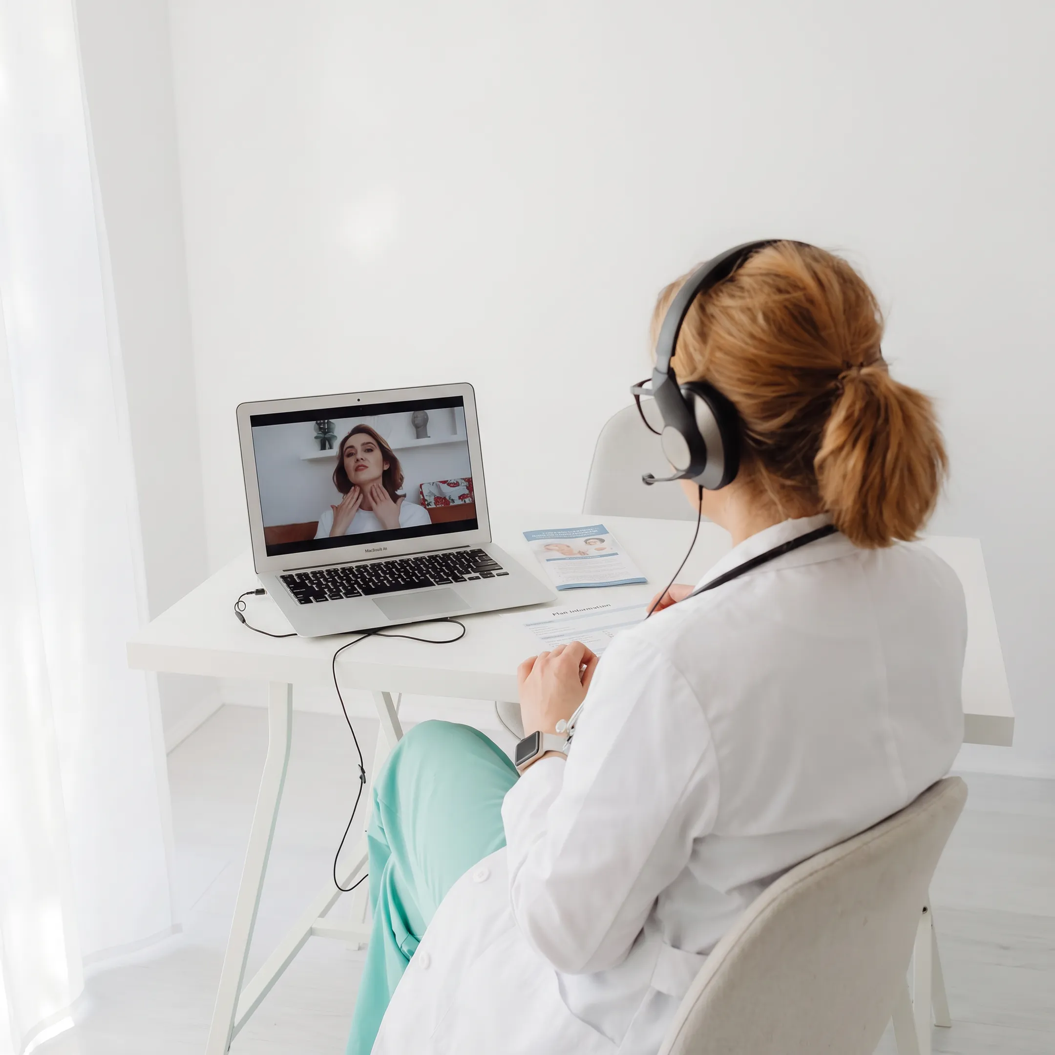 Doctor providing virtual primary care guidance to a patient at home