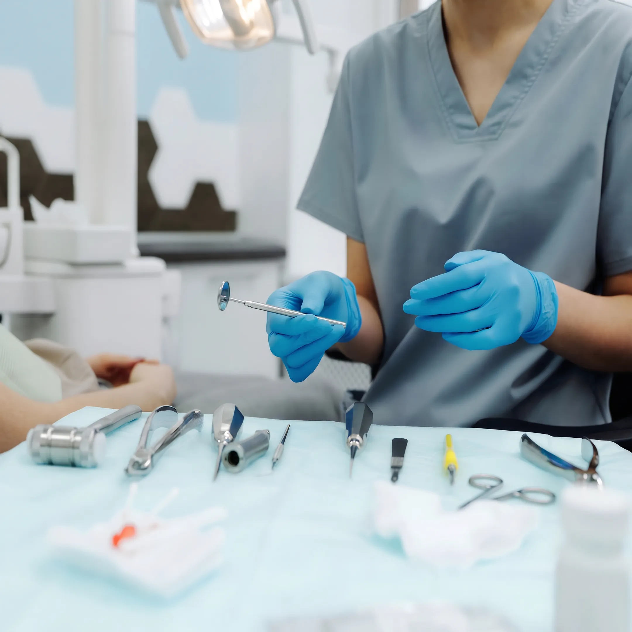 Dental hygienist preparing instruments for a routine patient cleaning