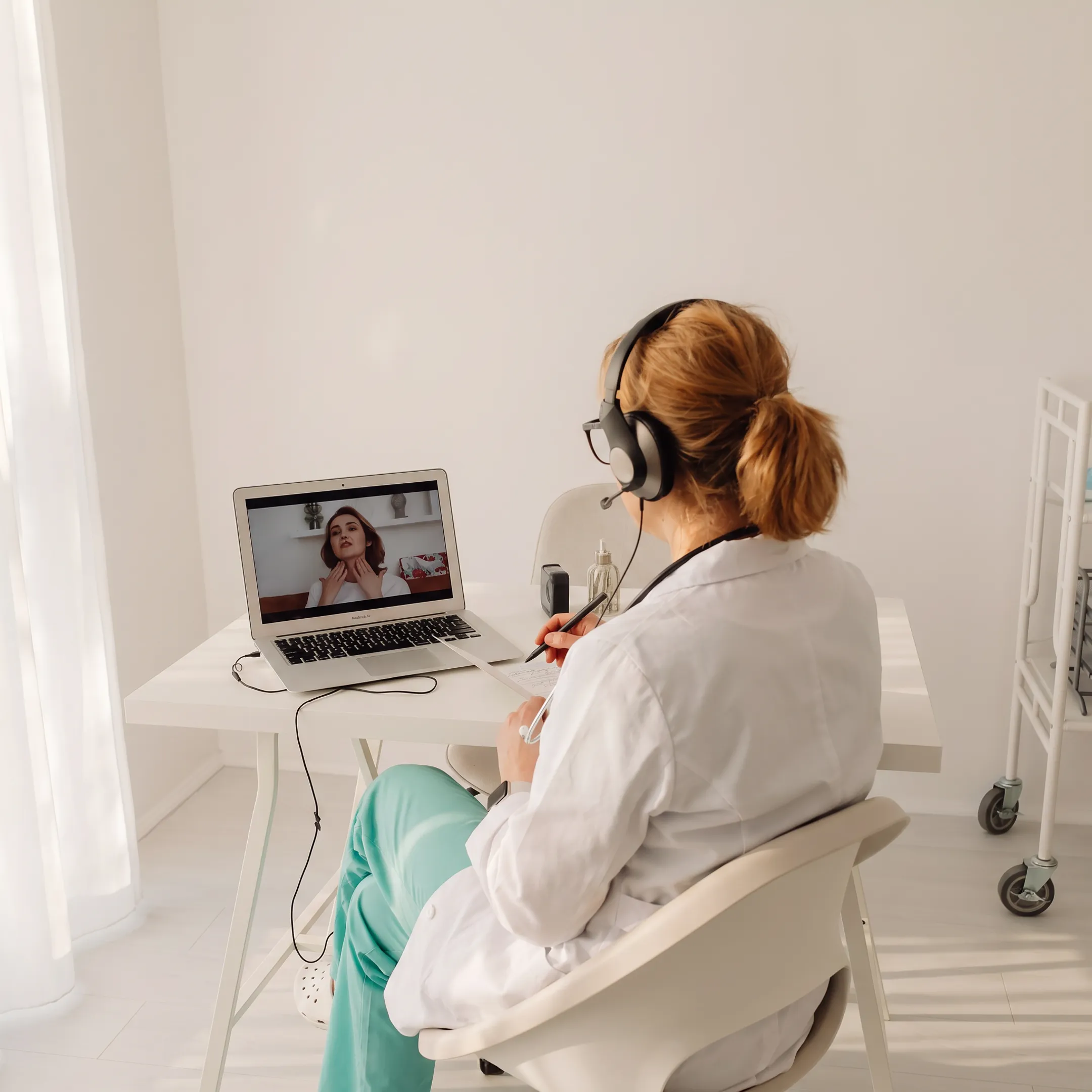 Doctor providing virtual care to a patient through a video consultation