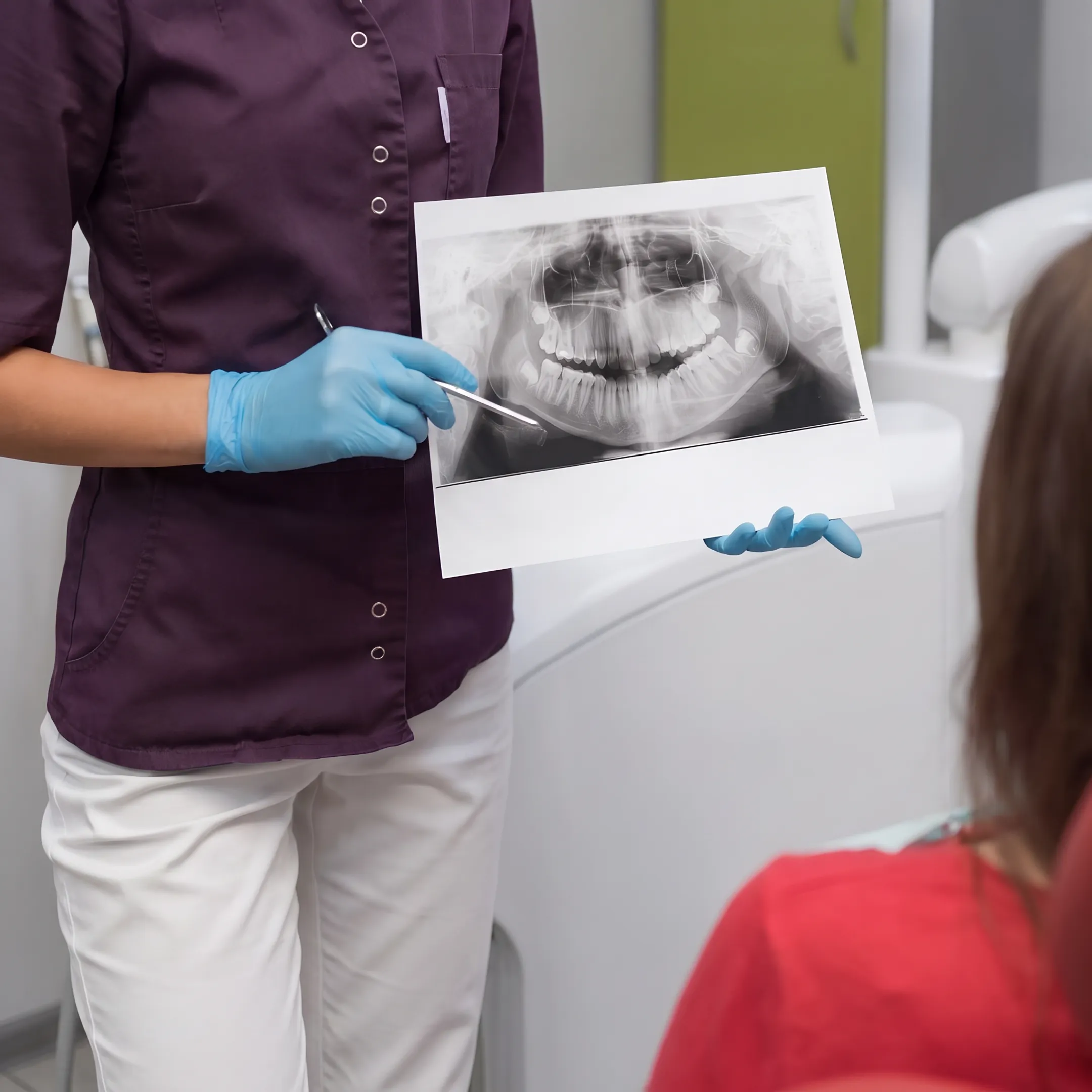 Dentist reviewing a dental care plan with an adult patient