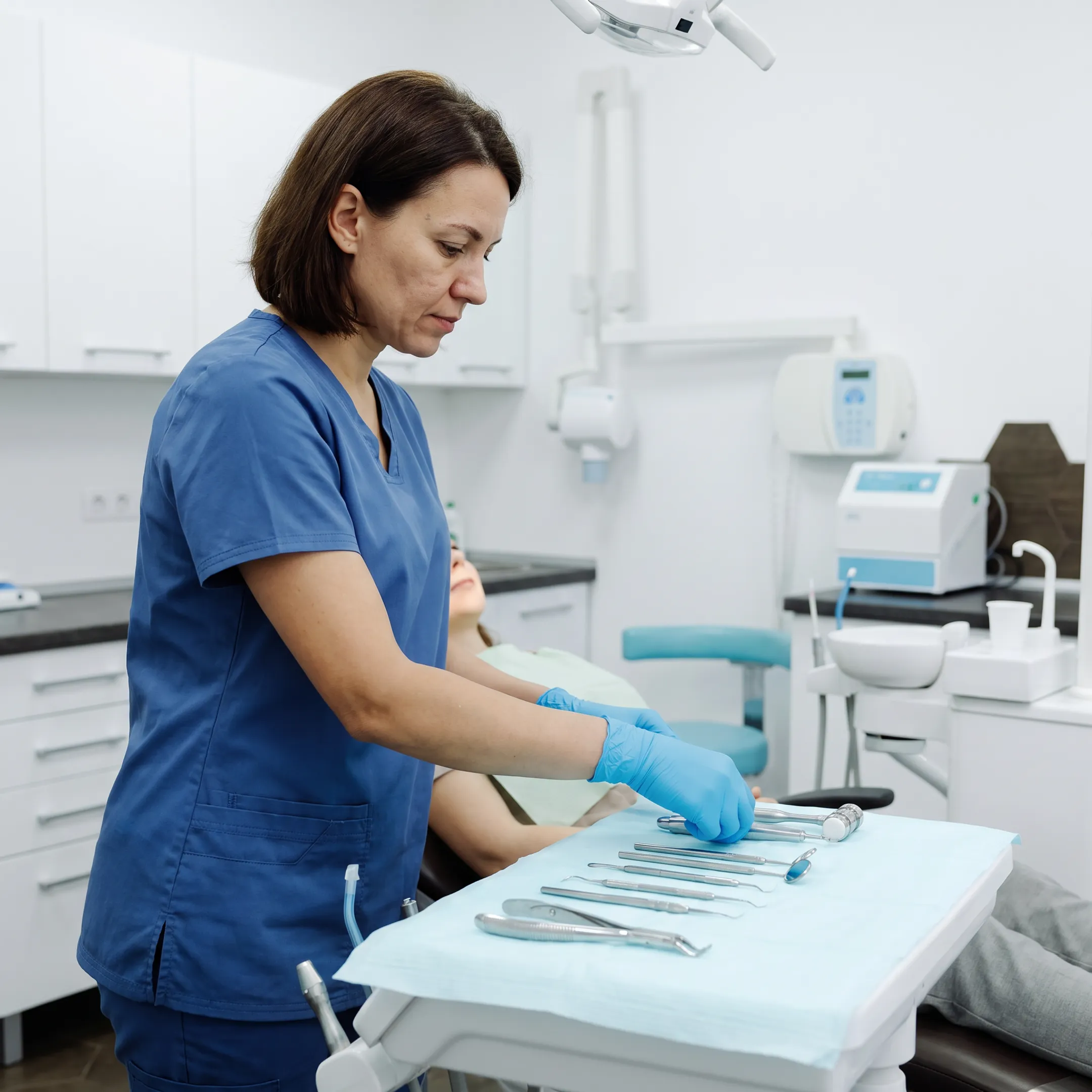 Dental professional preparing instruments for a routine teeth cleaning