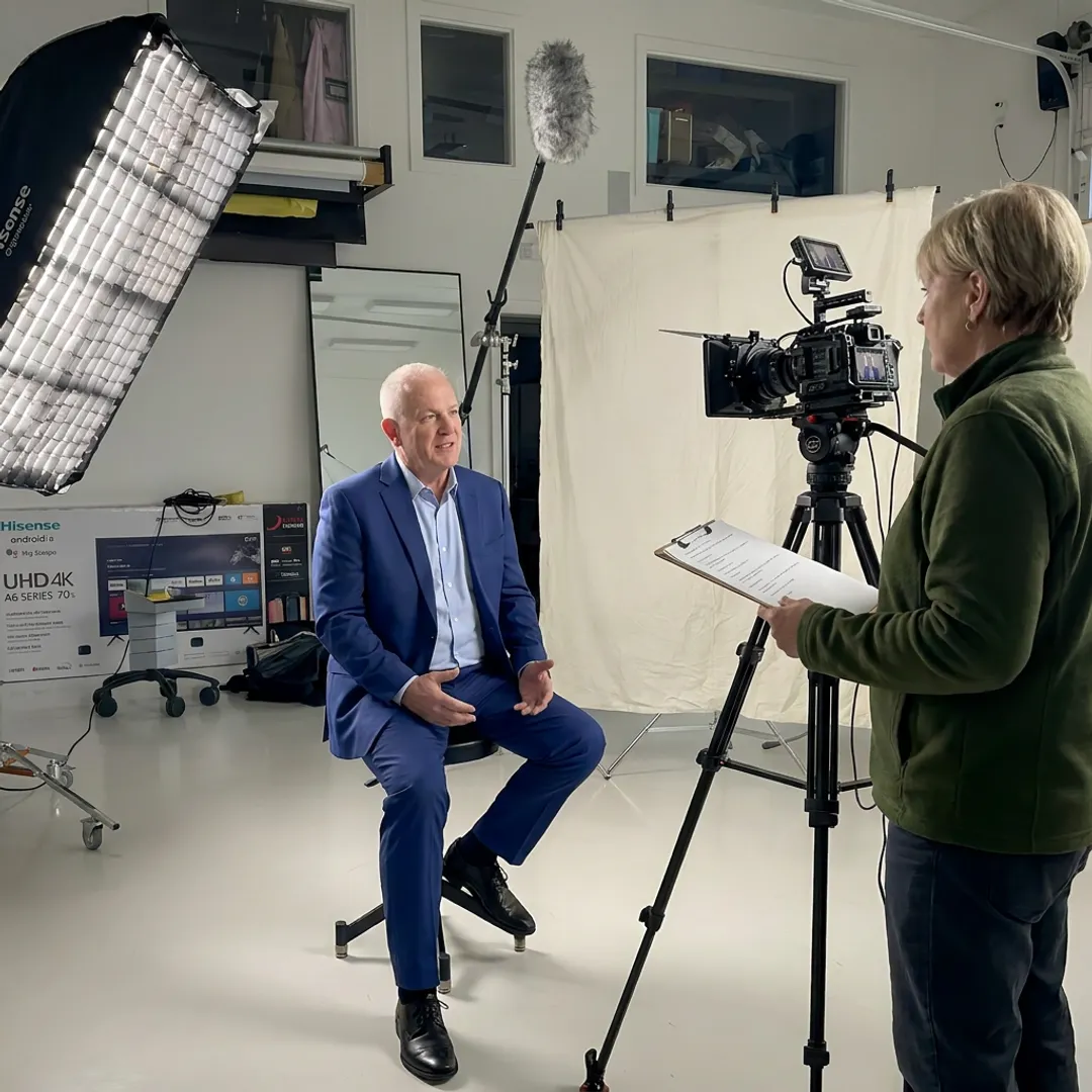 Video producer interviewing a client on camera