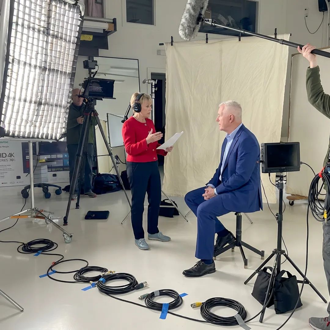 Video producer directing a customer interview