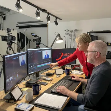 Video production team reviewing footage