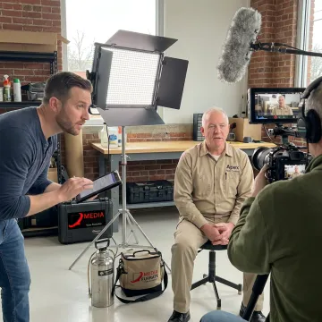 Video producer directing a pest control company interview