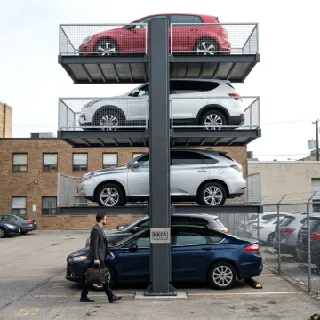 Urban parking lot with quad car stacking lift