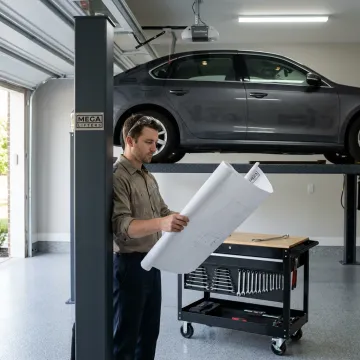 Technician planning a four-car garage lift layout