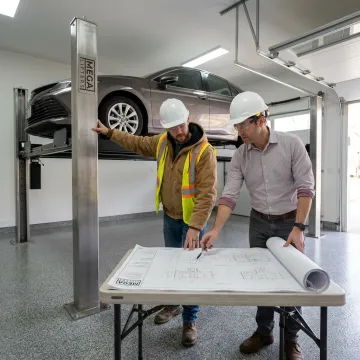 Technicians planning a custom car lift installation
