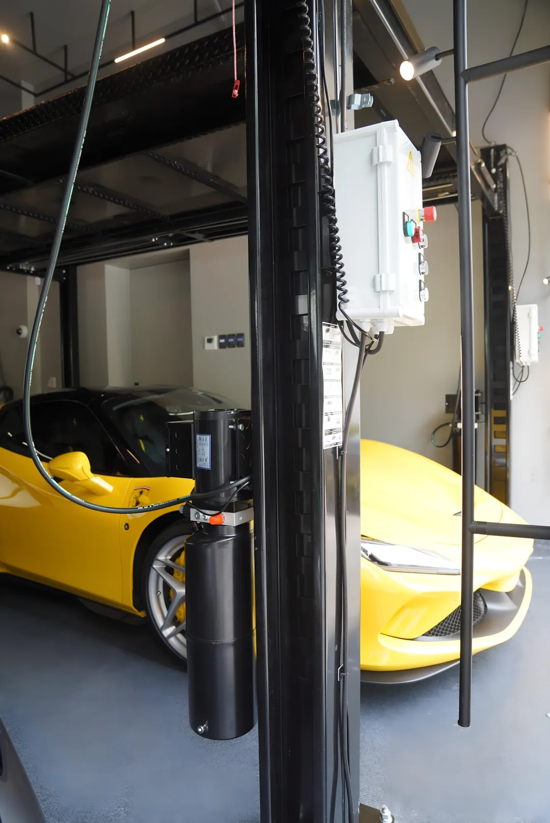 Residential enthusiast garage with stacked car lift