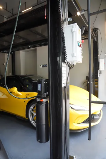 Residential enthusiast garage with stacked car lift