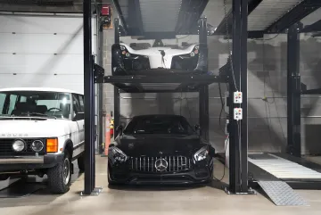 Multi-family residential parking garage with stacked lifts