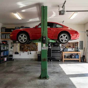 Single post car lift in garage
