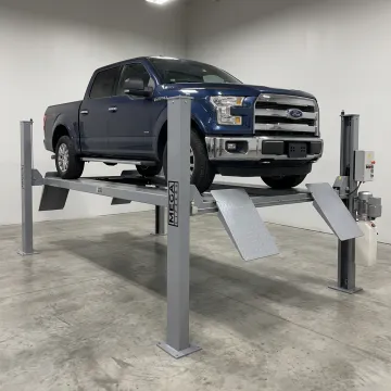 10000 lb four post car lift raising a vehicle