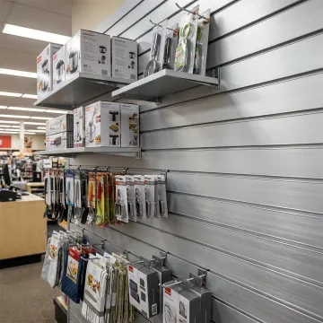 Metal slatwall display with shelves and retail products