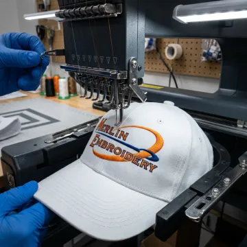 Embroidery machine stitching a captain hat