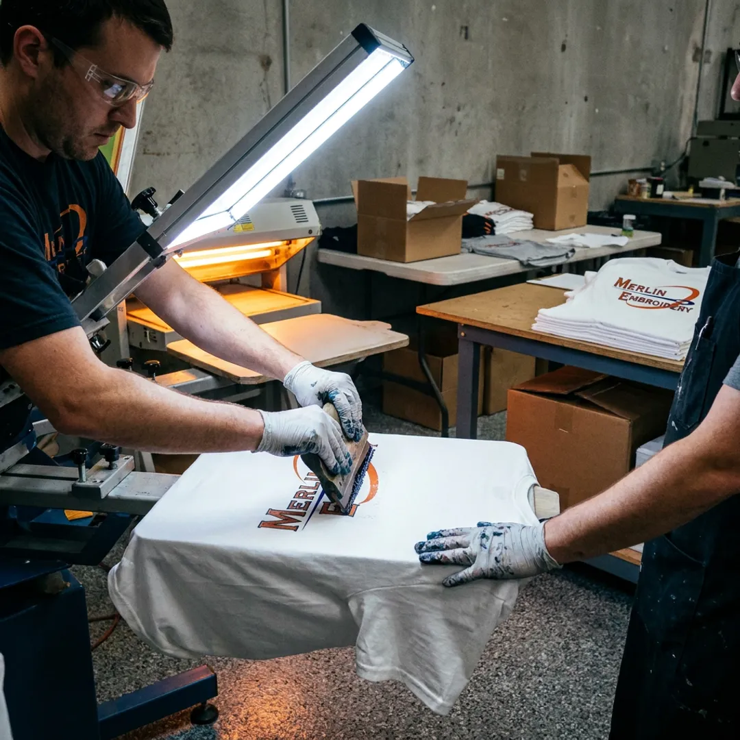 Technician screen printing branded shirts