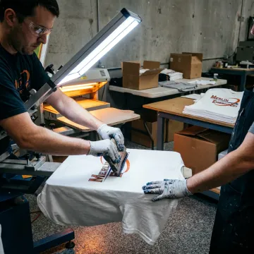 Technician screen printing branded shirts