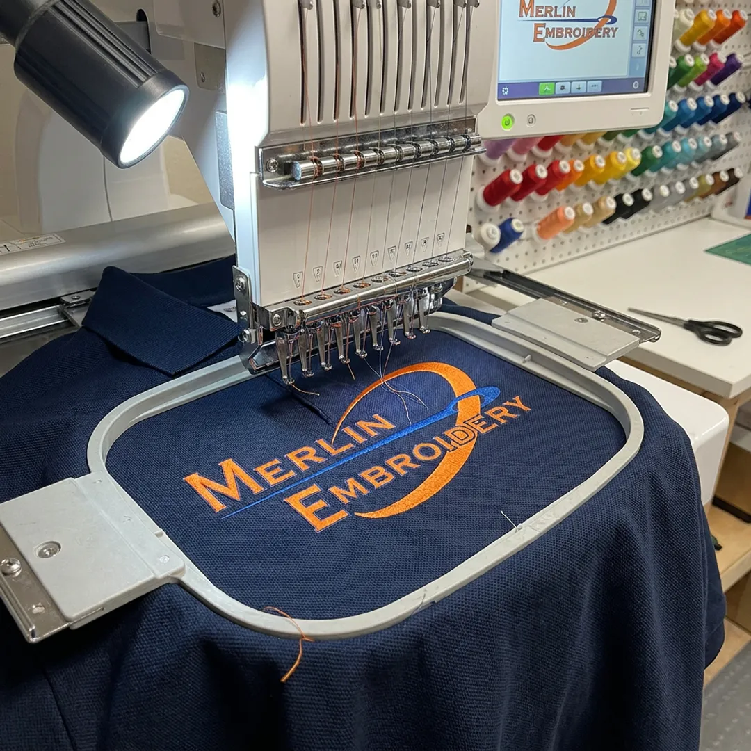 Embroidery machine stitching a police polo shirt