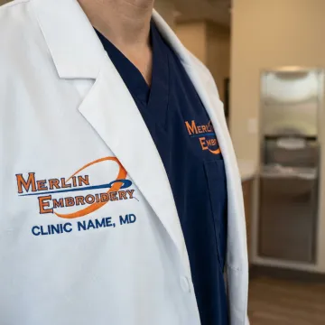 Embroidered lab coat and scrubs with medical logo