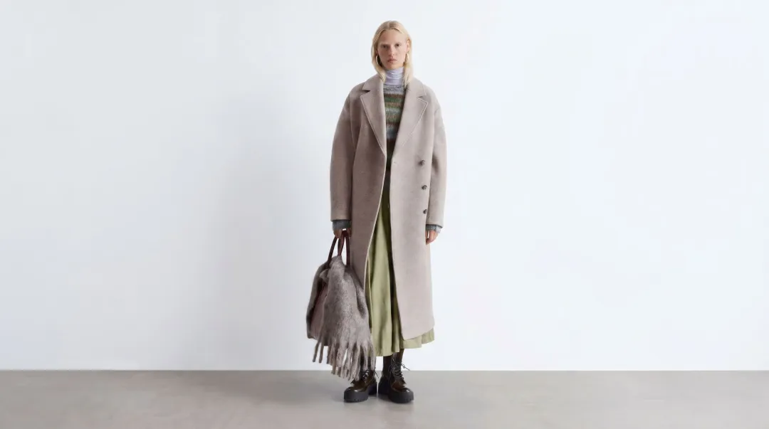 Oversized luxury wool coat styled on model showing full silhouette and drape