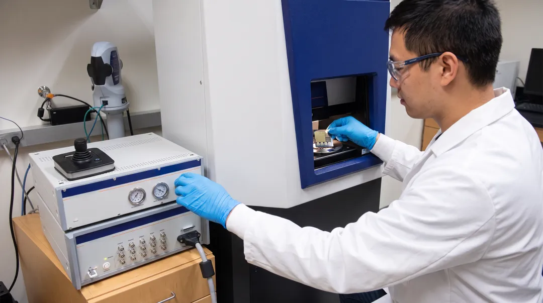 Scientist operating atomic force microscope for materials science research