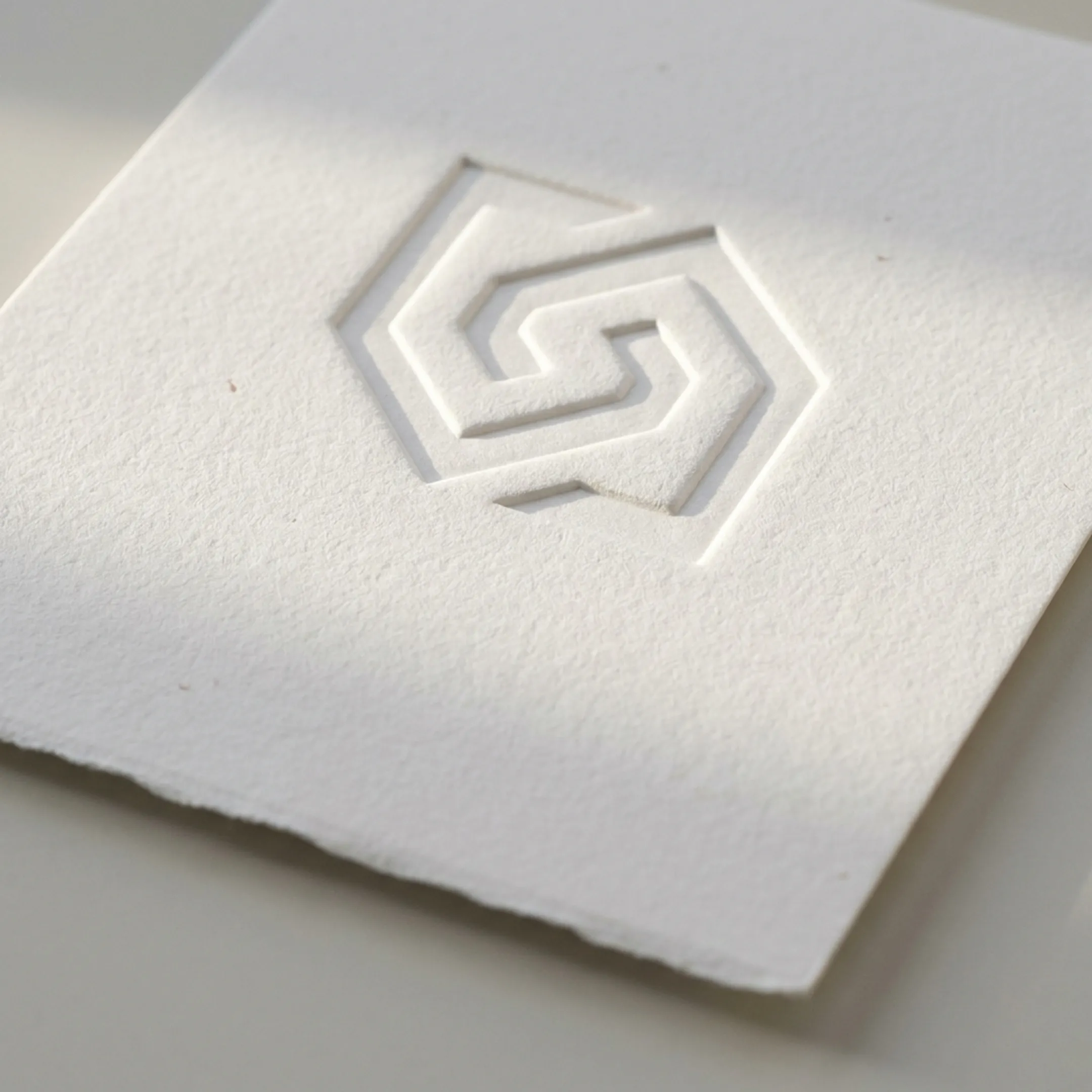 Blind embossed logo on premium white paper