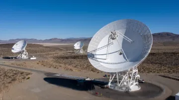 Large radio telescope parabolic dish in open landscape deep space communications facility