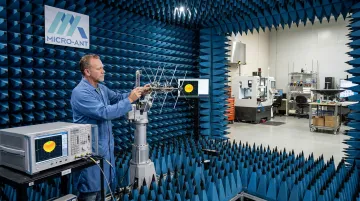 Engineer testing antenna performance inside near-field test chamber facility