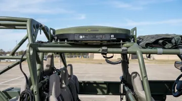 Military tactical vehicle with flat panel antenna mounted for mobile satellite communications