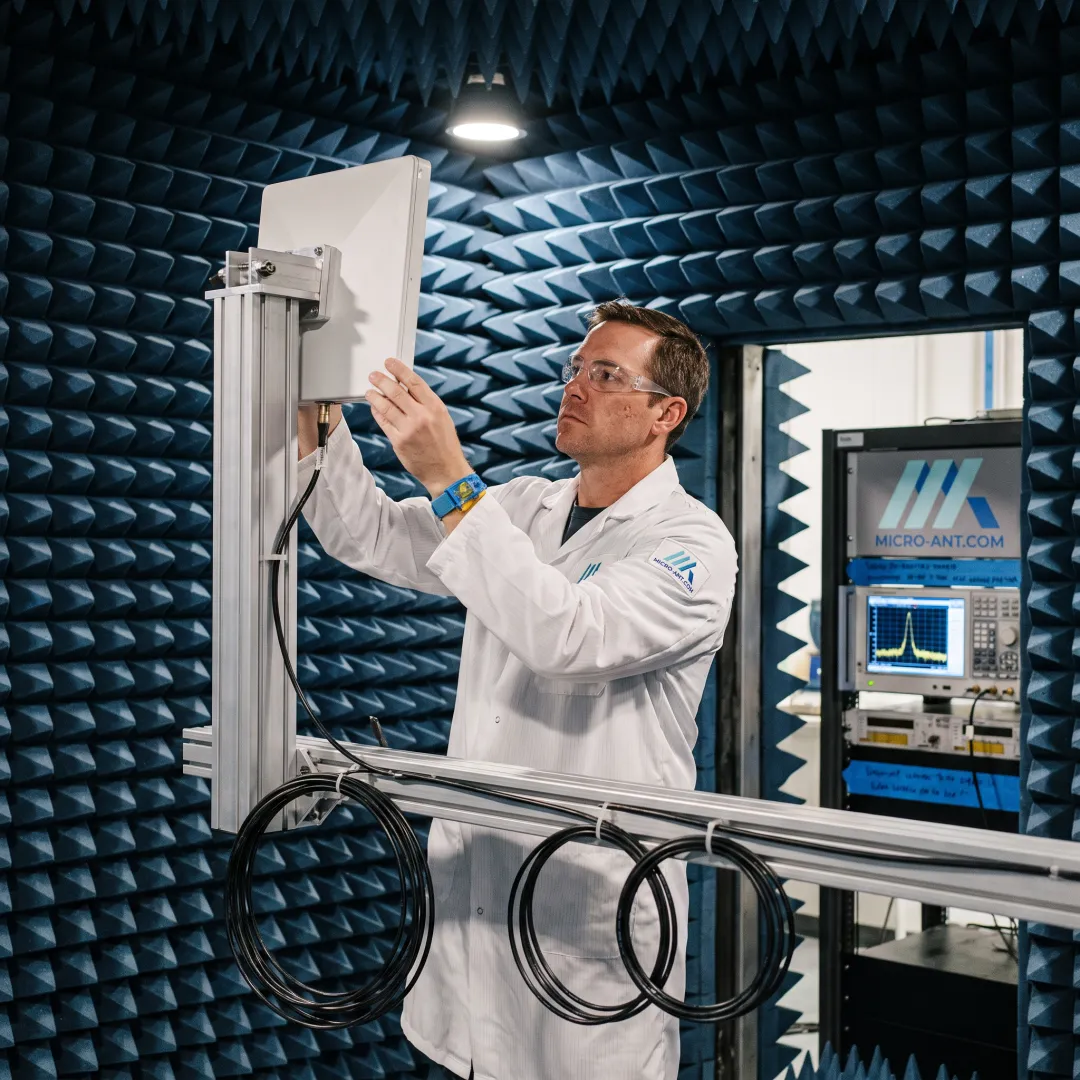 RF engineer testing a custom antenna in a near-field measurement chamber
