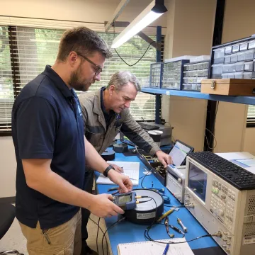 Engineers testing a SATCOM antenna terminal