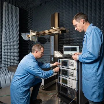 Engineers testing a custom RF antenna in a lab