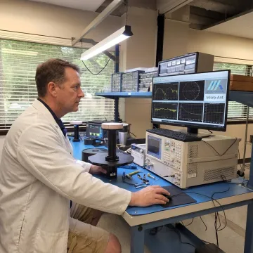 Engineer testing an RF antenna in a lab
