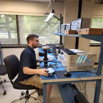 Engineer reviewing RF antenna test data in a lab