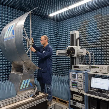 Engineer performing antenna measurement in a near-field chamber