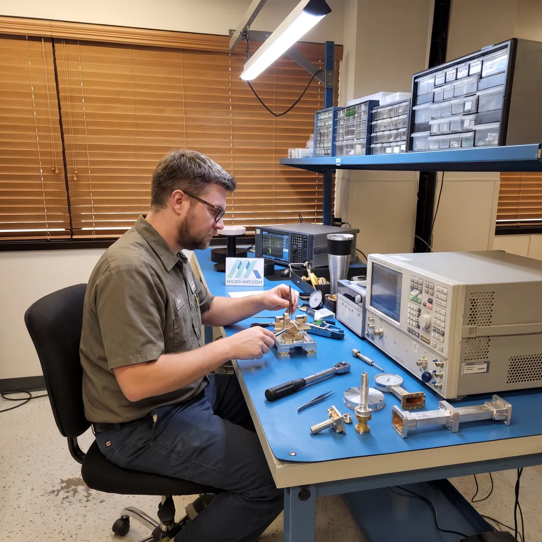 Technician assembling a precision RF antenna