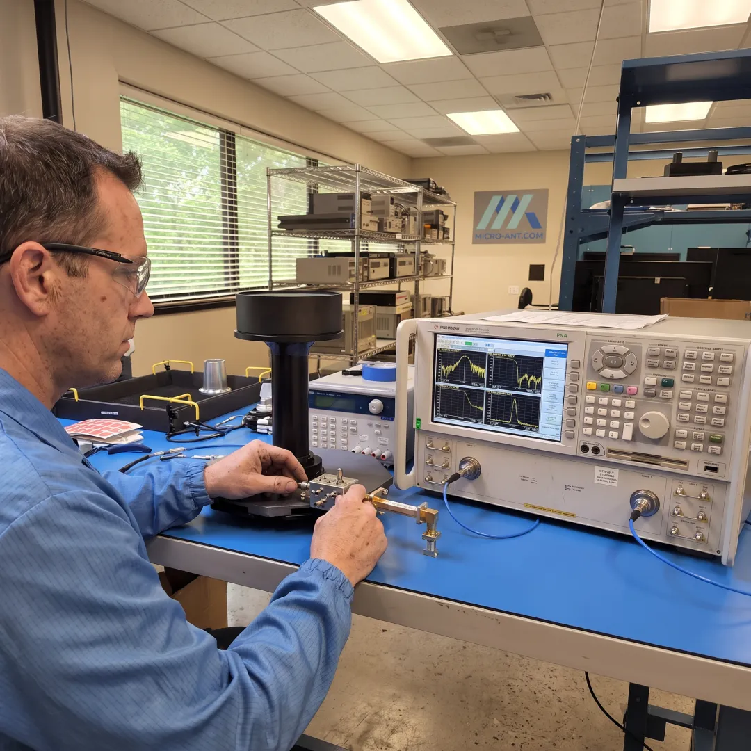 Engineer testing an RF filter component in a lab environment