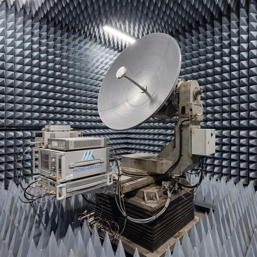 Engineer testing a SATCOM antenna in an anechoic chamber