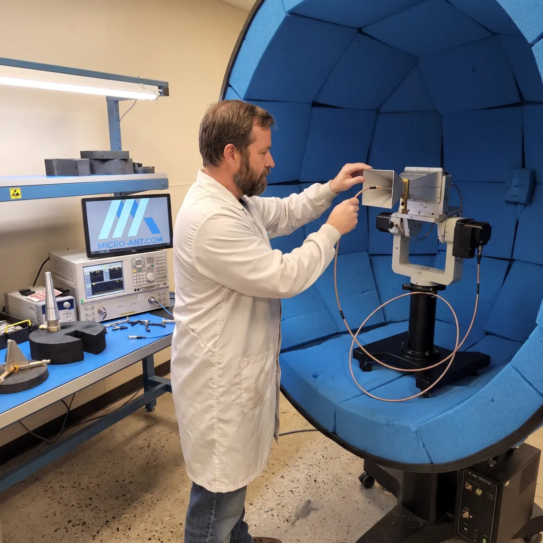 Engineer testing an antenna inside a near-field anechoic chamber