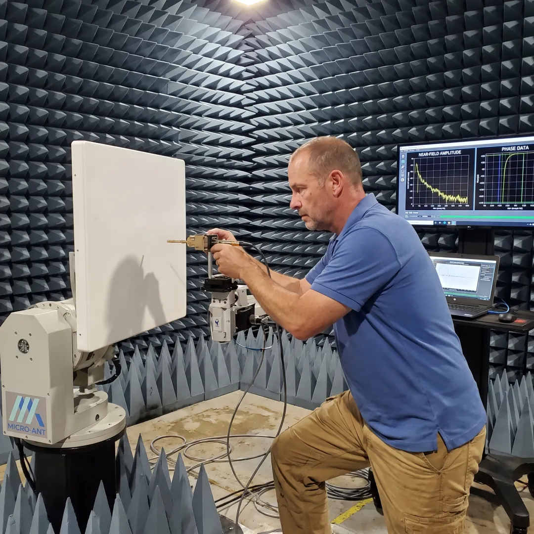 Technician testing a flat panel antenna