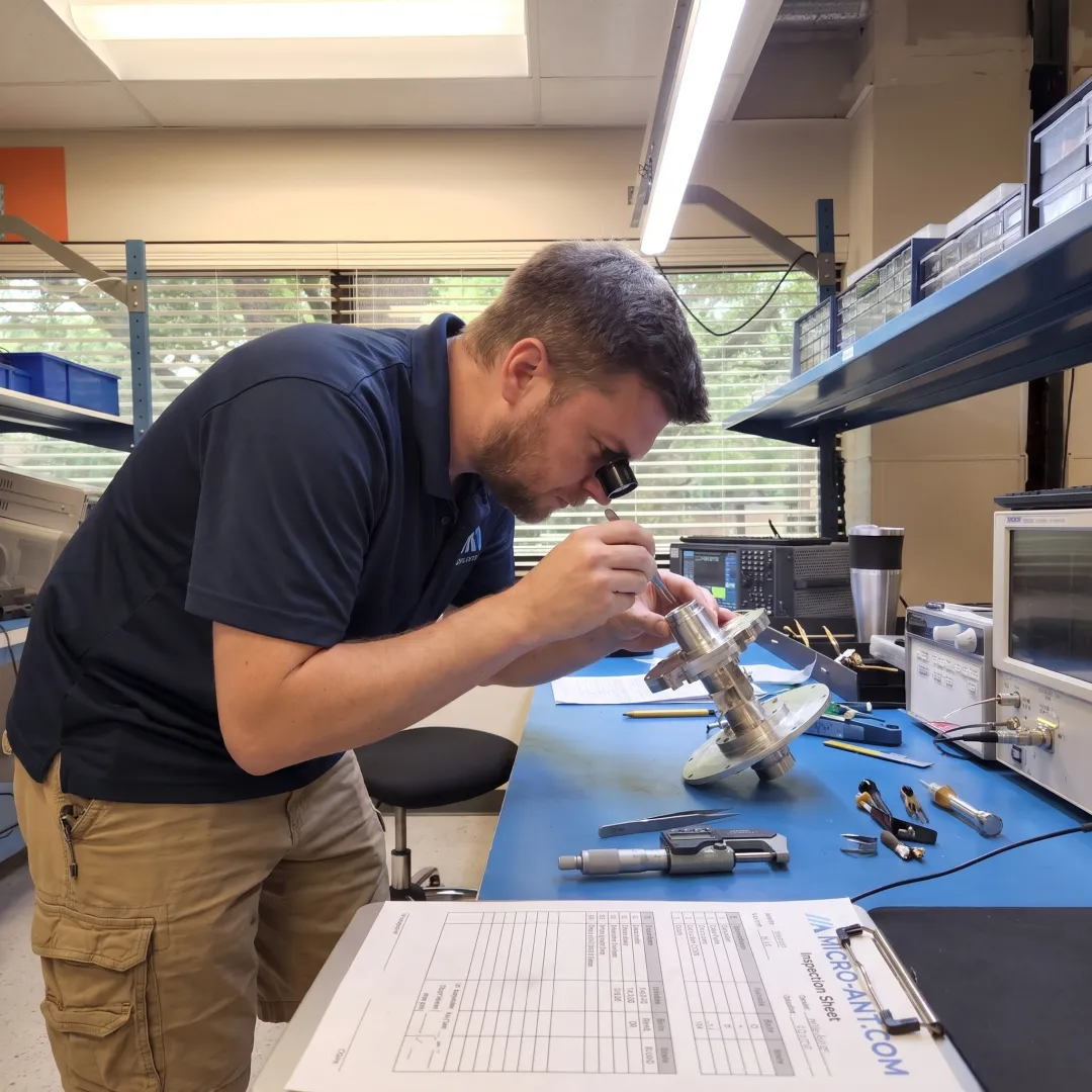Custom X-band antenna assembly undergoing inspection