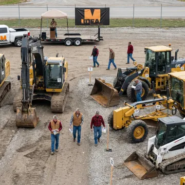 Live auction yard with used heavy equipment