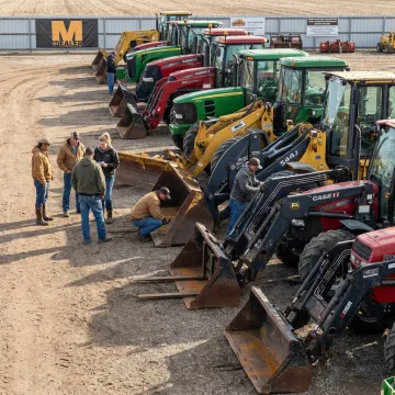 Farm equipment lined up for auction inspection
