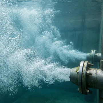 Jet aeration nozzles creating micro-bubbles in wastewater treatment tank