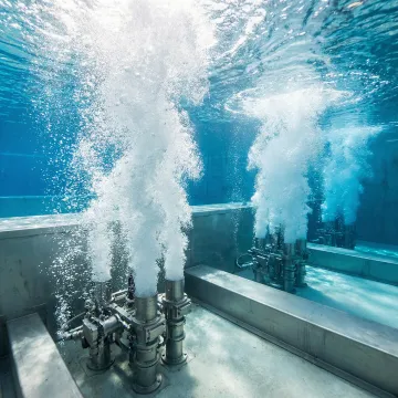 Close-up of submerged jet aeration nozzles creating fine bubble patterns in wastewater