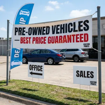 Custom dealership signs on an auto lot