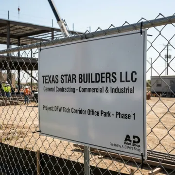 Construction job site sign near active building project