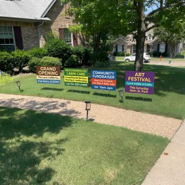 Custom yard signs displayed on a Dallas lawn
