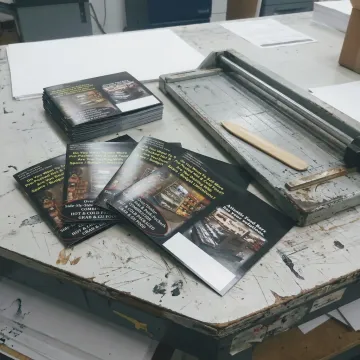 Finished 8.5 x 11 brochures on a print shop table