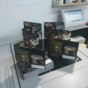 Stack of custom 8.5x11 flyers being printed